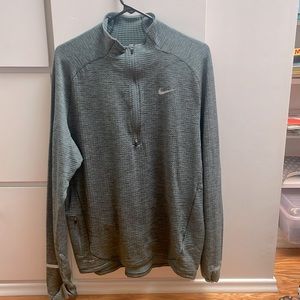 Nike Dri-fit running 1/4 zip pullover with reflective strips and pocket.